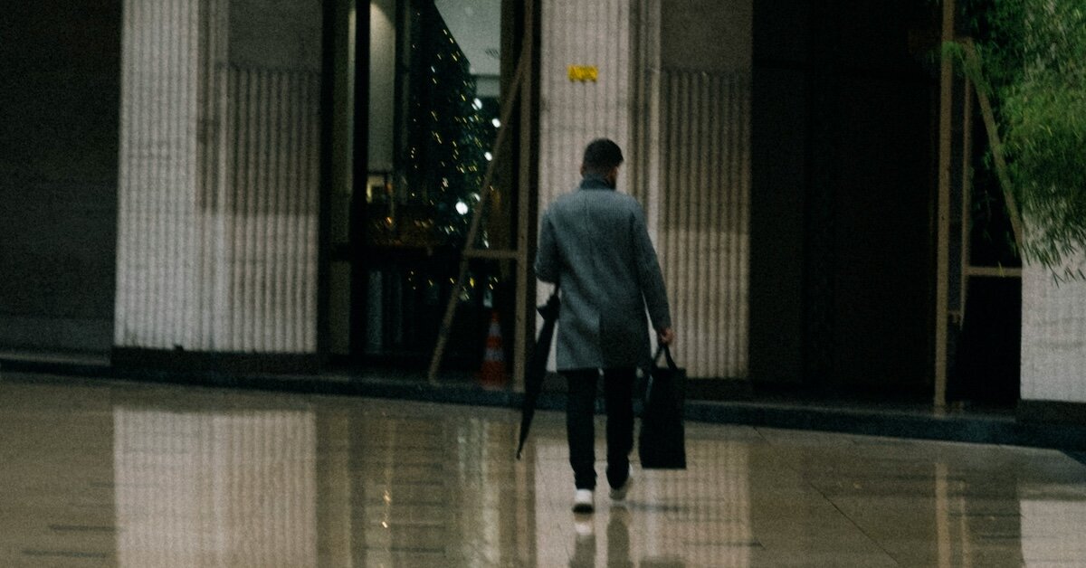 A person walking into the bank to meet with a CRE lender