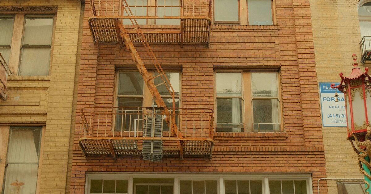 A building with a For Sale sign on the side