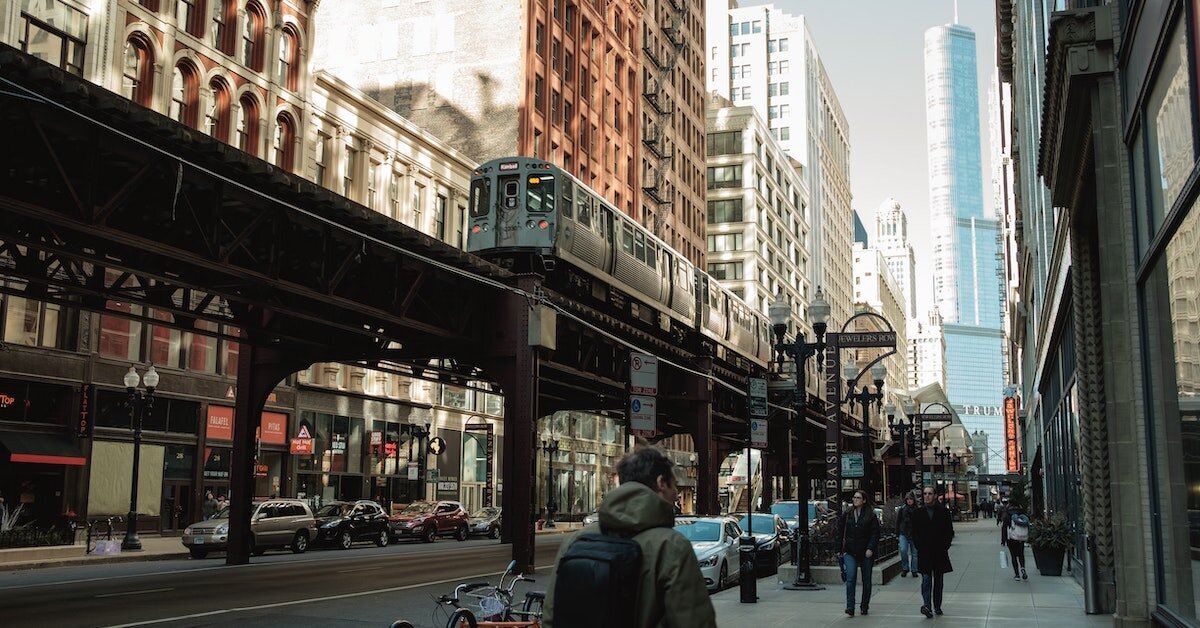 The Chicago Loop train during the day driving by multifamily apartment buildings in downtown CBD