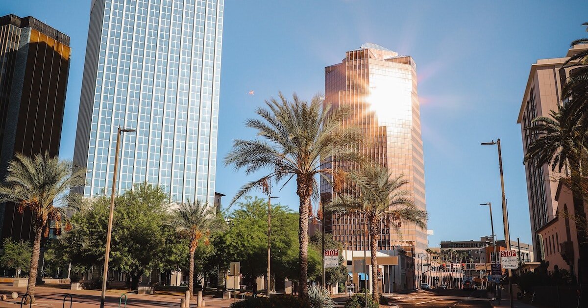 The sun glints off a tall office building in Tucson