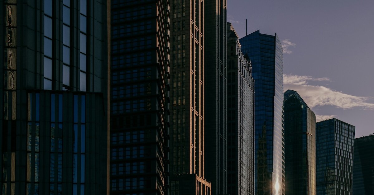 Dark buildings in silhouette against sunset