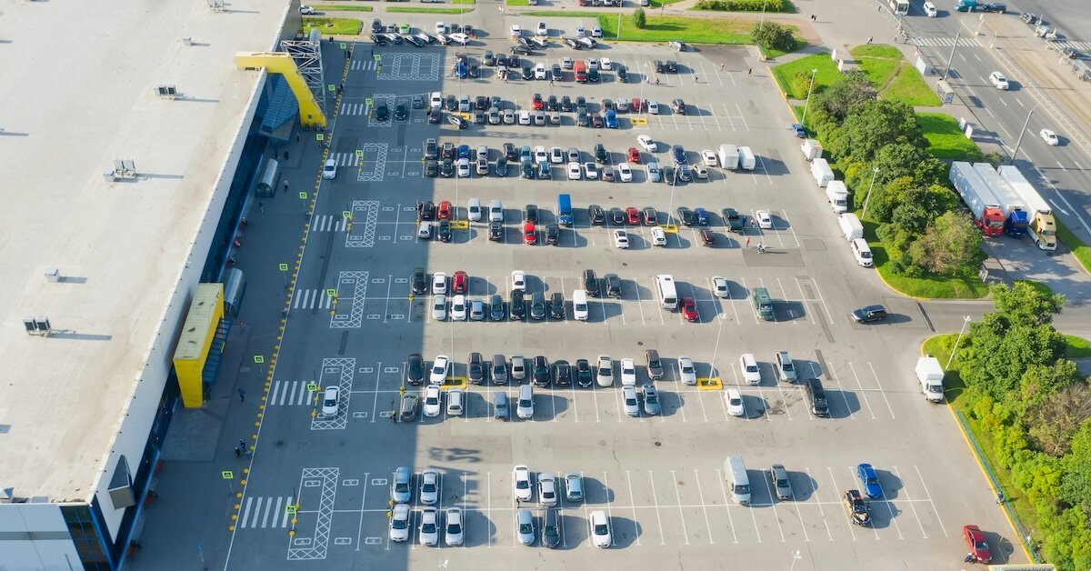 parking lot outside of a shopping center as seen by a drone