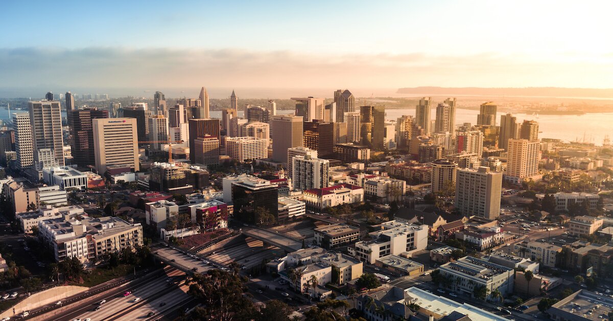 Donwtown san diego at sunset with a view of the bay and apartment buildings