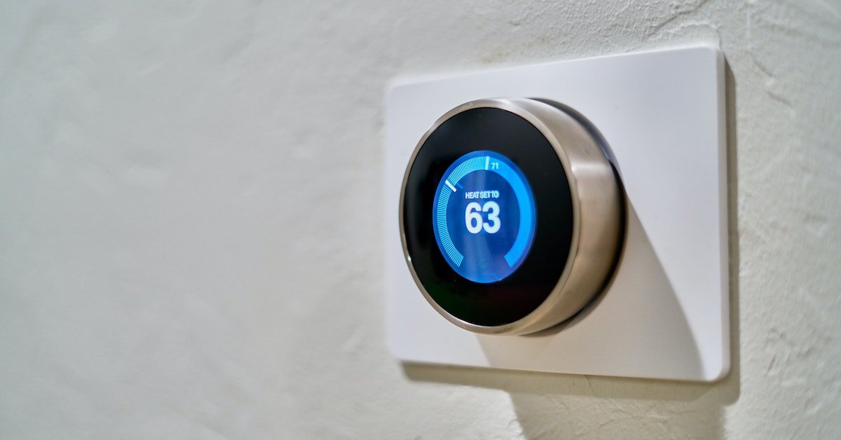 a Nest thermostat setting the heat to 63 degrees.