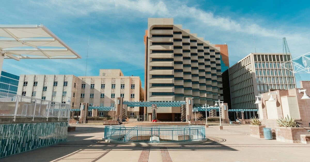 The outside of a rooftop bar with hotel buildings in the background
