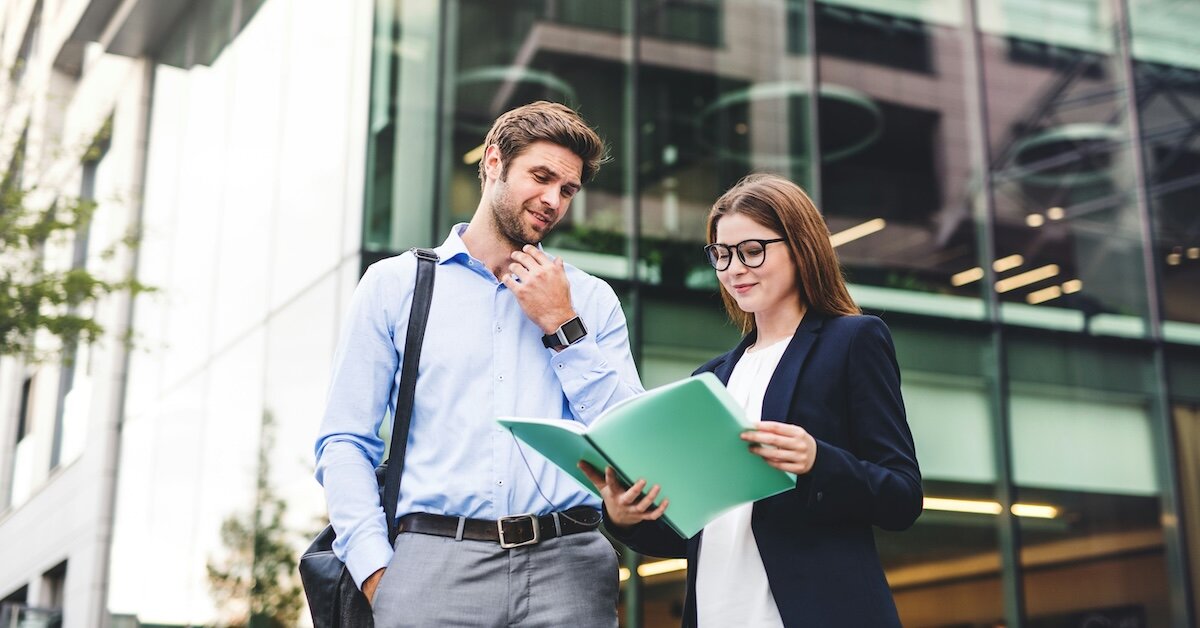two brokers reviewing a proposal to represent a seller
