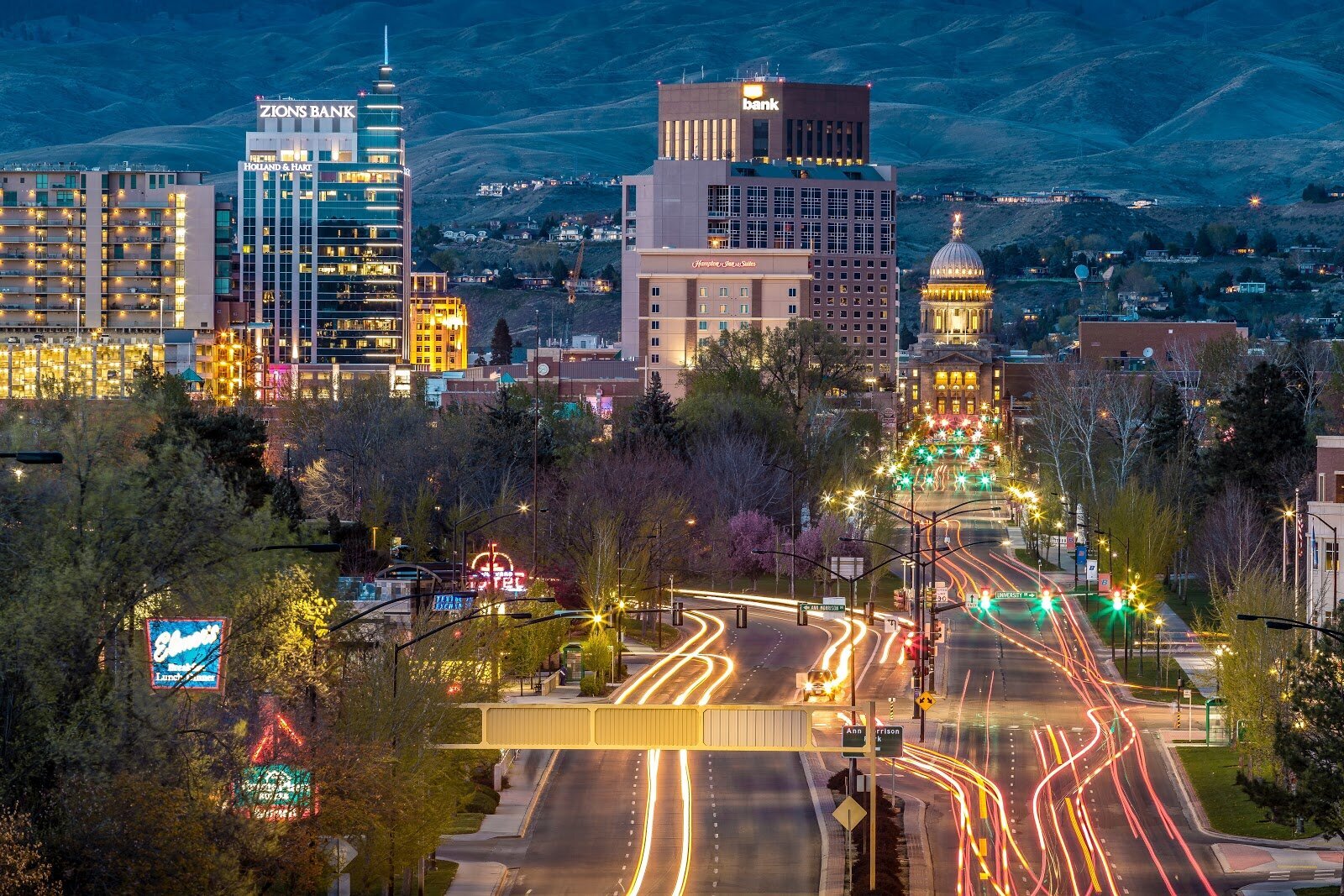 A timelapsed photo of downtown Boise at night with car headlines streaking down the main streets