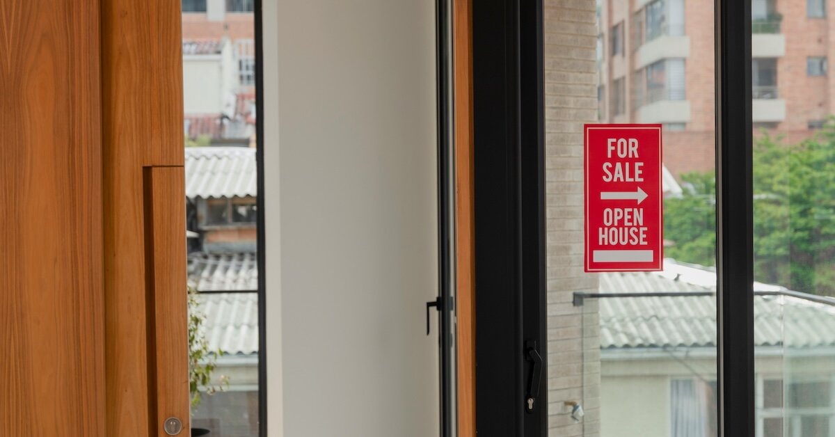 building with a for-sale sign in the window