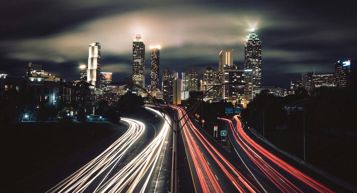 Atlanta with freeways of delayed exposure cars driving in and out of the lit up city at night