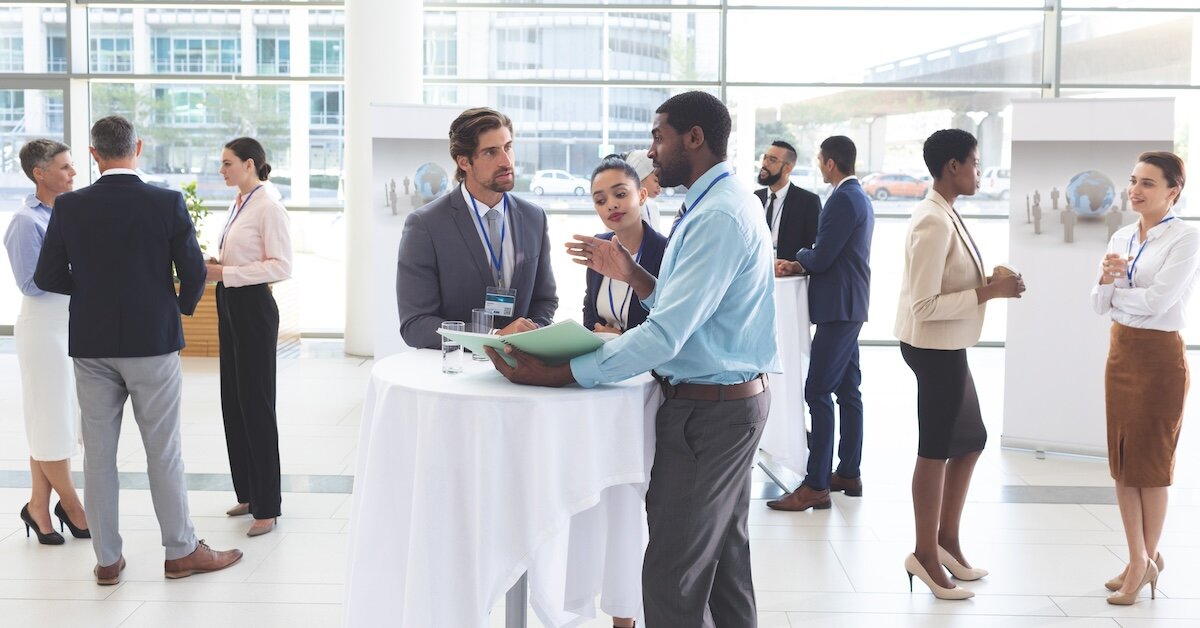 Workers at a conference review AI tools in conversation