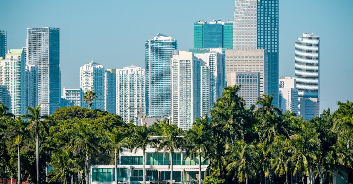 Downtown Miami office skylines dot the horizon with retail shops in the foreground