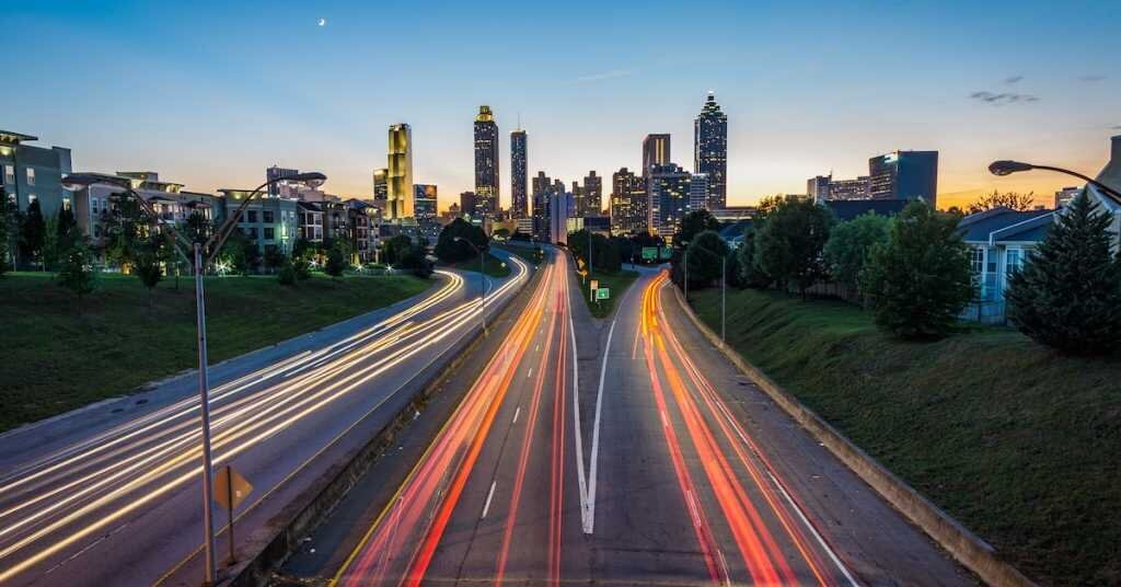 A timelapsed photo of an Atlanta highway at sundown, facing into the downtown portion of the city.