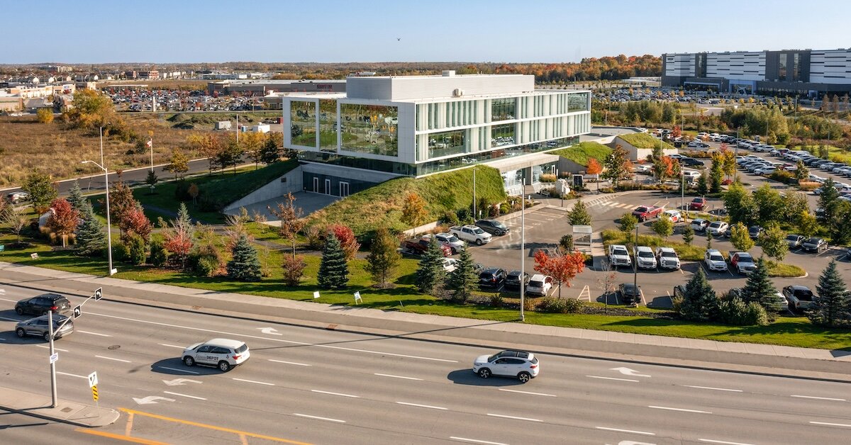 An office building with a trafficked road in the foreground