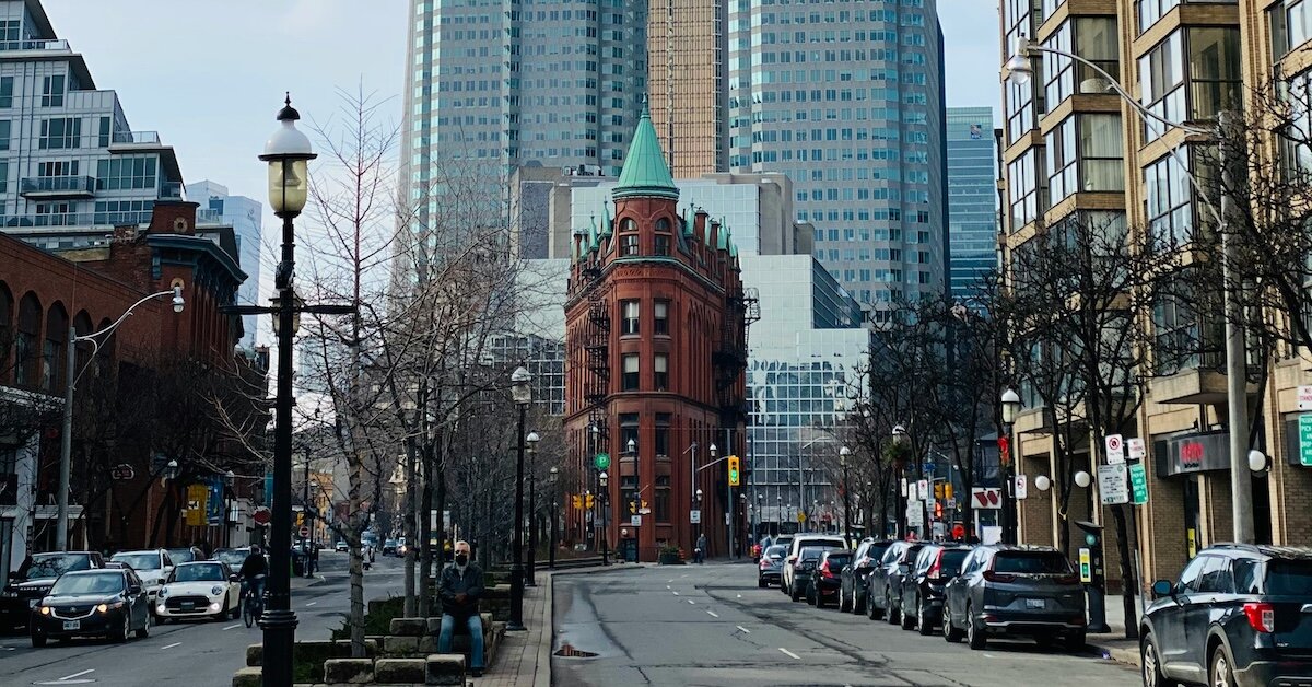 a historic building surrounded by skyscrapers