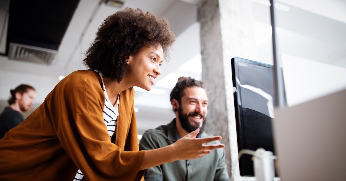 Two people review security features on a laptop