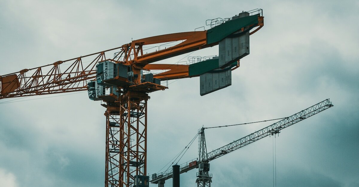 Two large construction crane towers