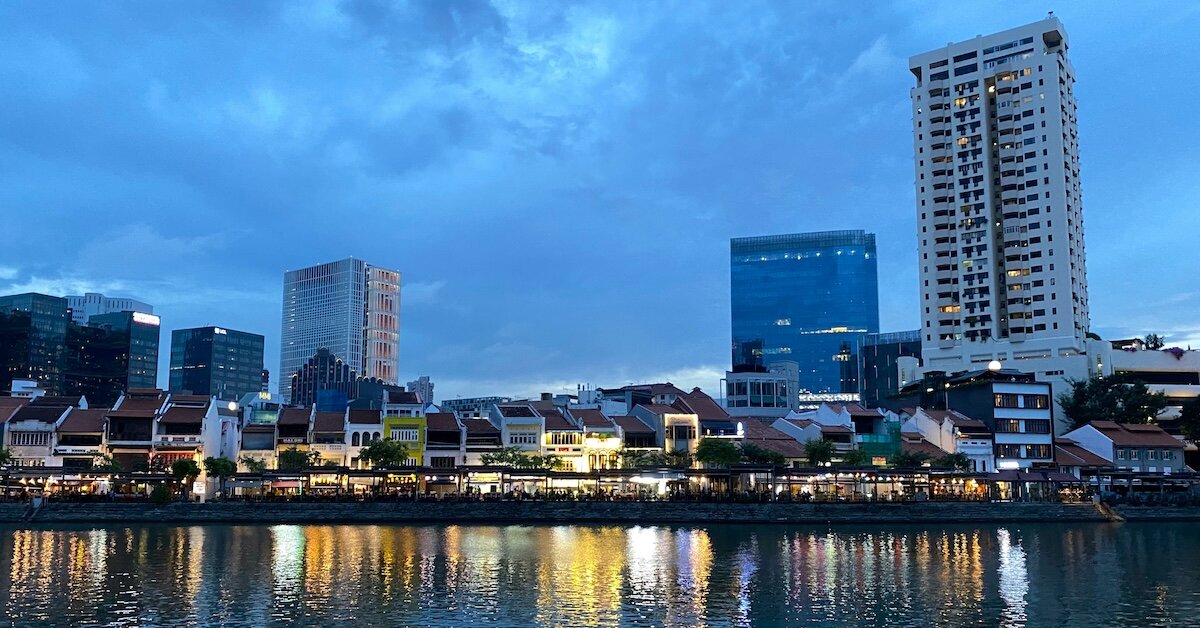 a city skyline at night reflected in the bay