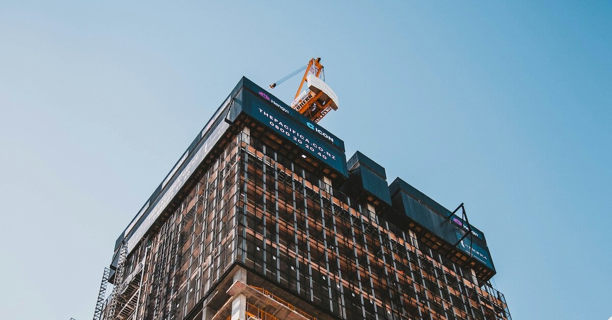 A crane on top of a building under construction