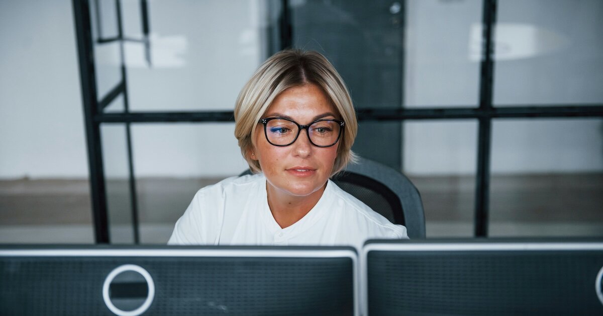 A broker managing leads on two computer screens