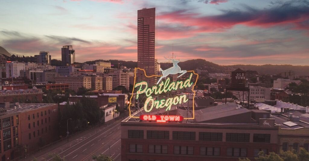 A sign of old town Portland Oregon at sundown