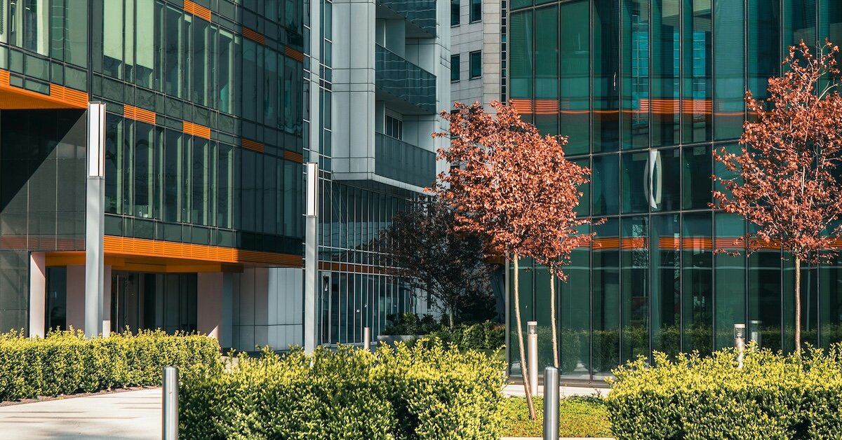 outside of an office building with foliage in the courtyard