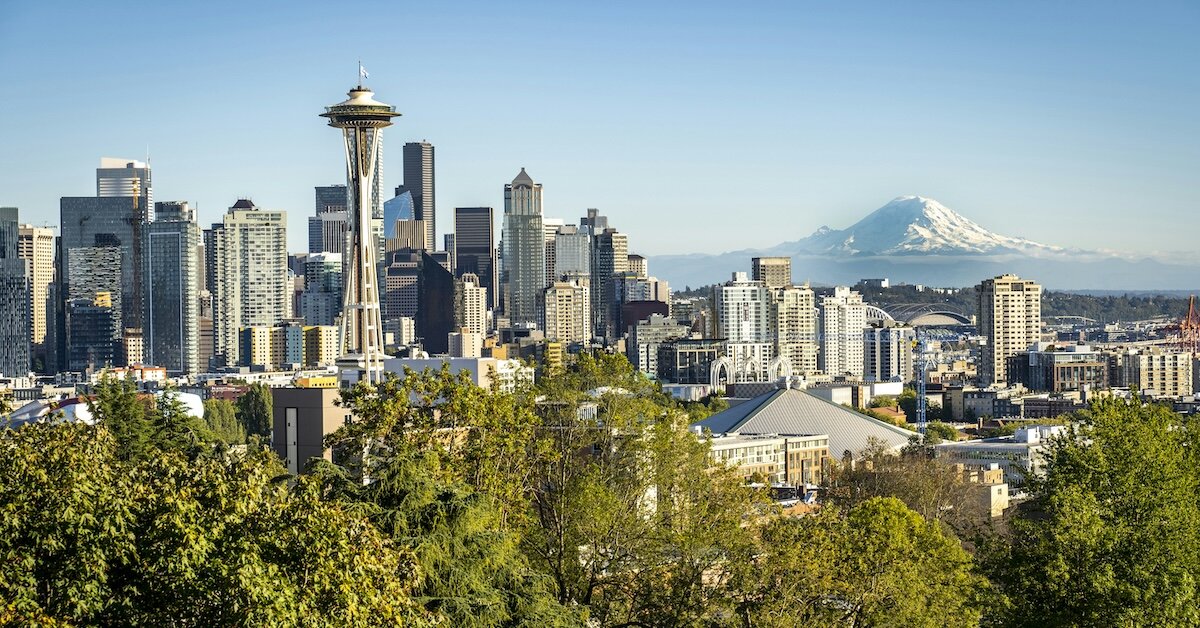 The whole of downtown Seattle with many office and multifamily apartment buildings around the space needle