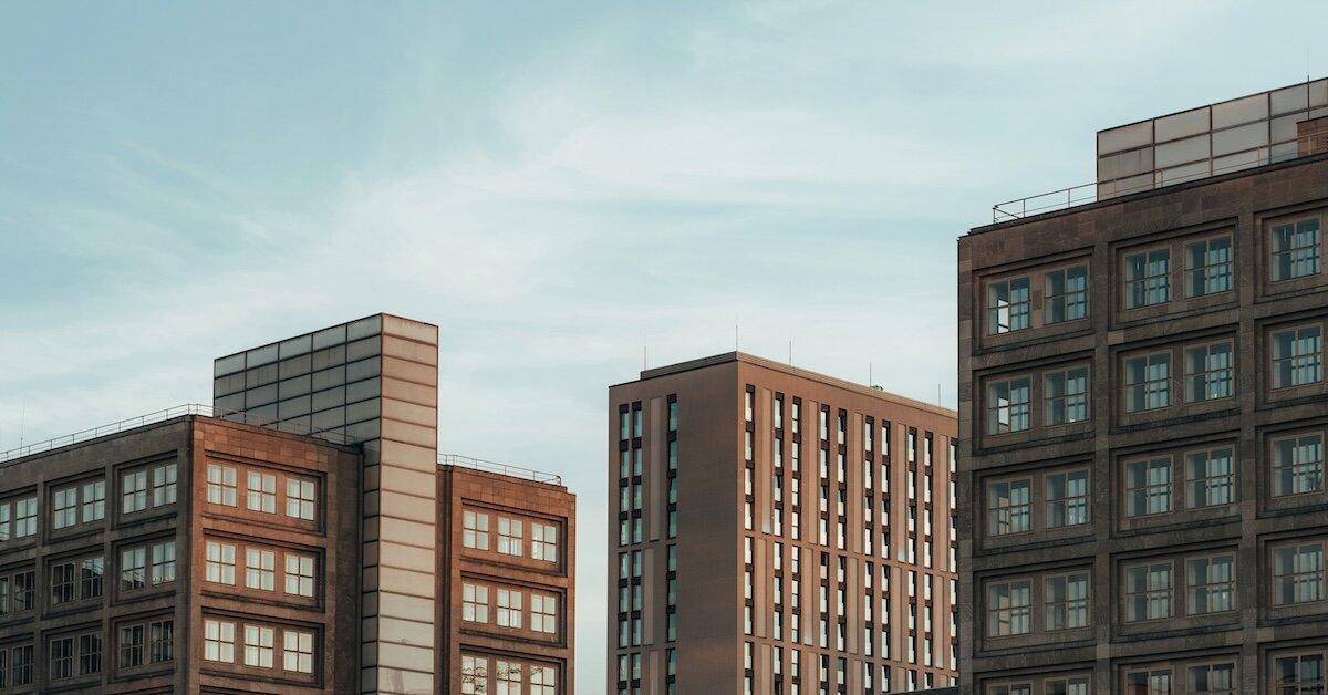 A series of commercial real estate buildings stand in order of increasing height