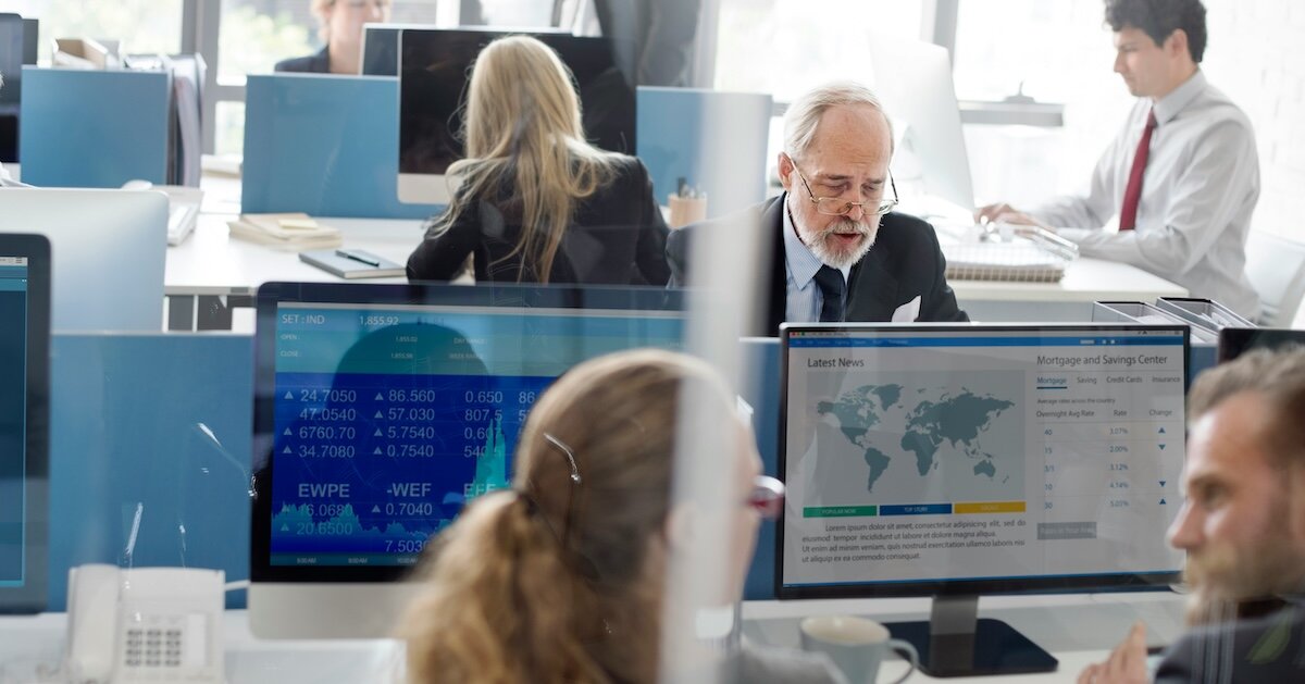 Several folks looking at maps and data while doing comps research