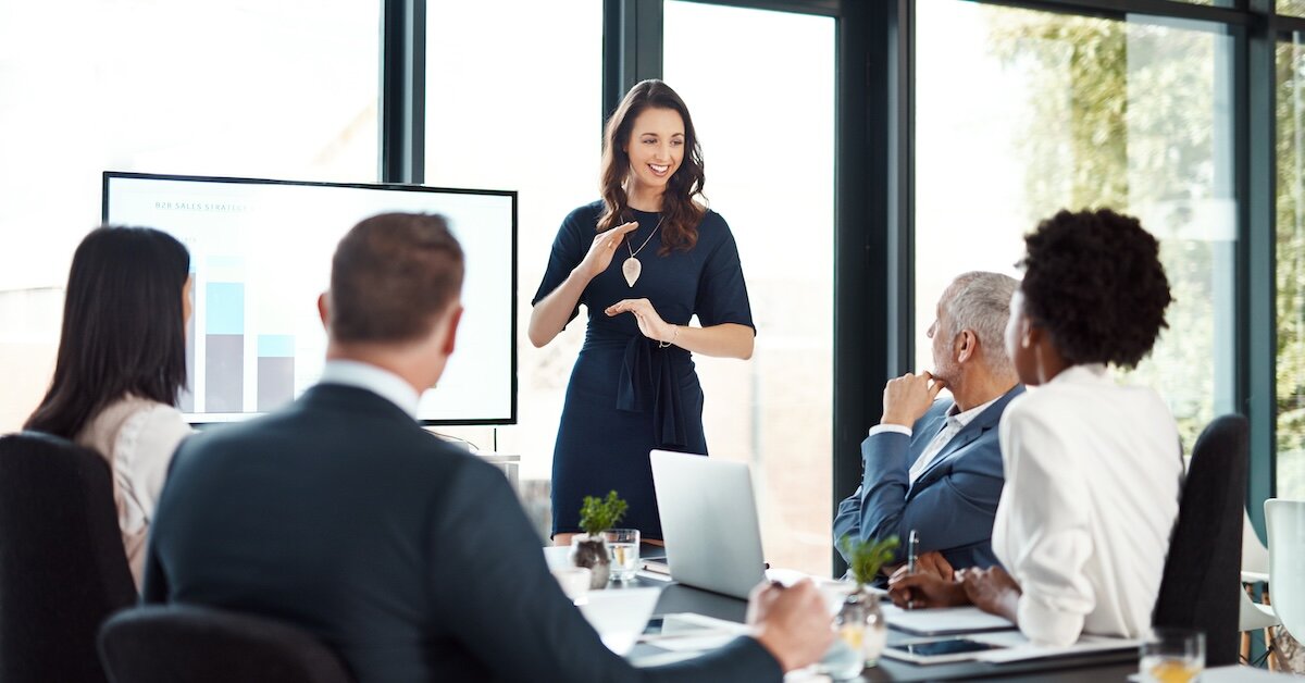 A business woman giving a presentation to a group of fellow professionals