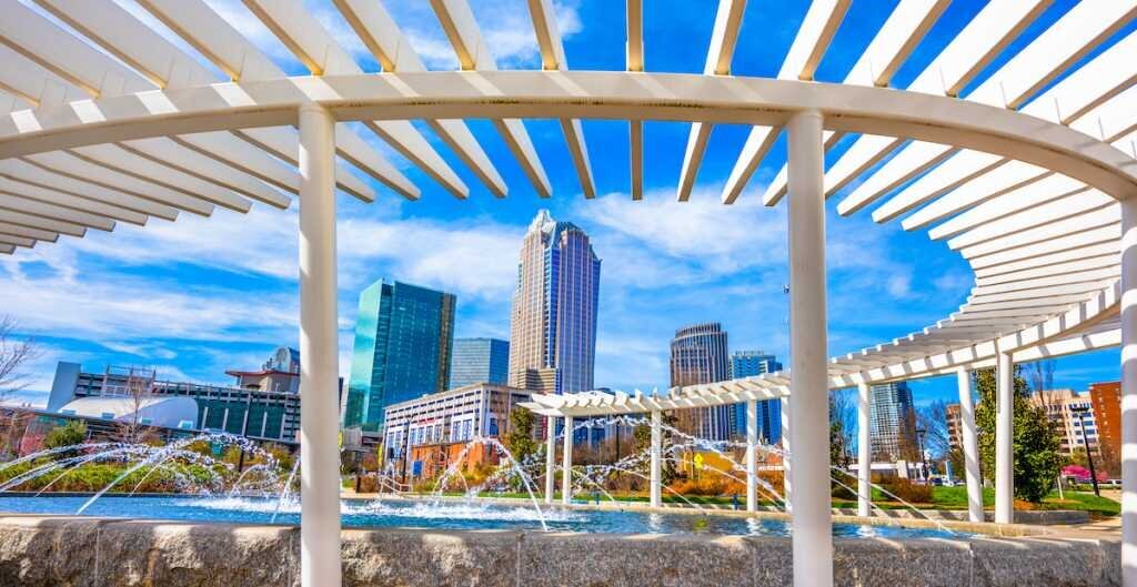 A water feature in Charlotte surrounded by office buildings 