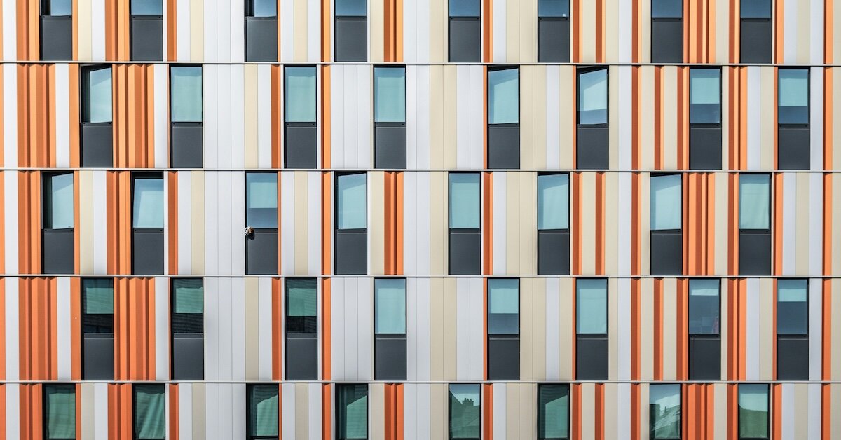 Exterior of a orange-and-cream colored building with many windows