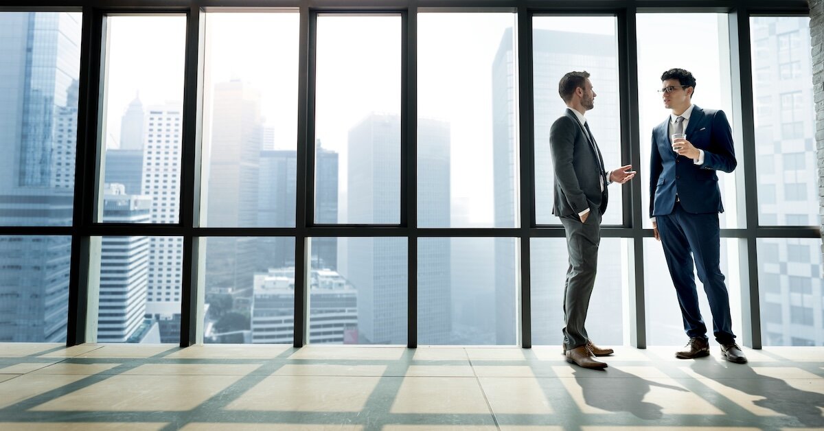 two brokers reviewing business things in an office