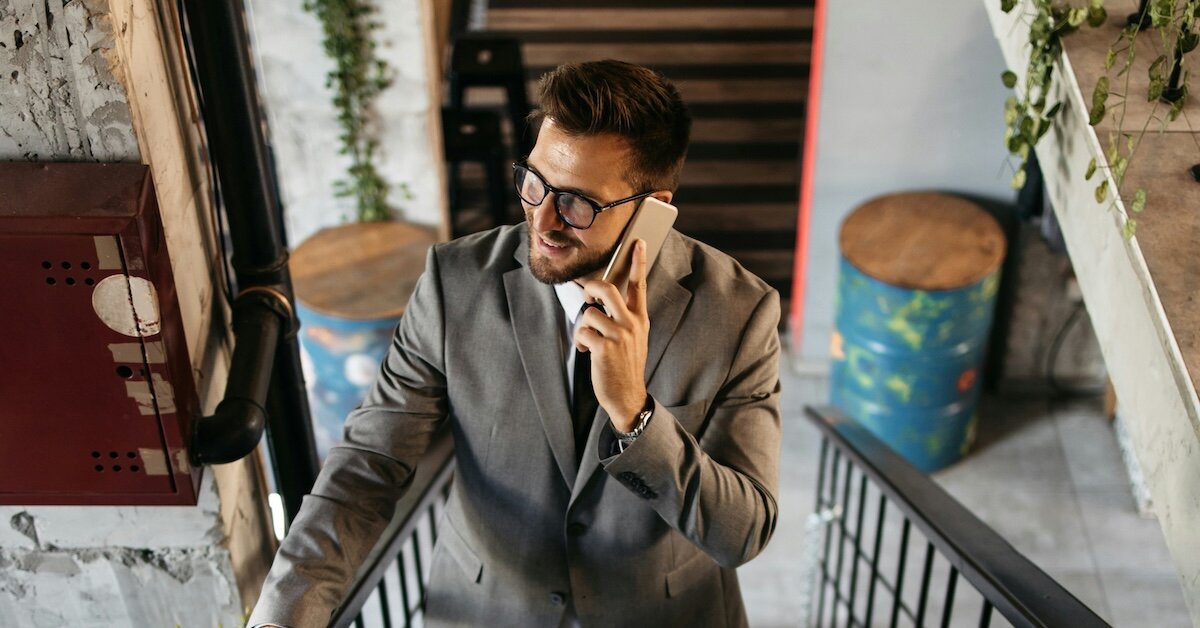 A broker on a phone call climbing upstairs