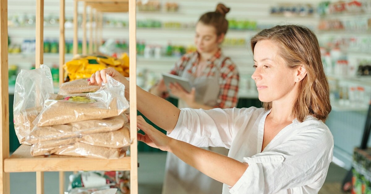 person in a retail store restocking items