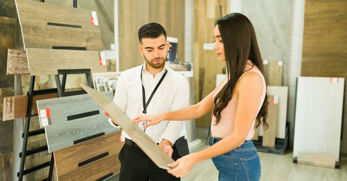 two people looking at floor samples as an example of redevelopment costs