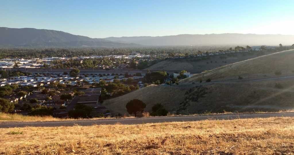 A valley with San Jose single family and multifamily homes nestled in the background