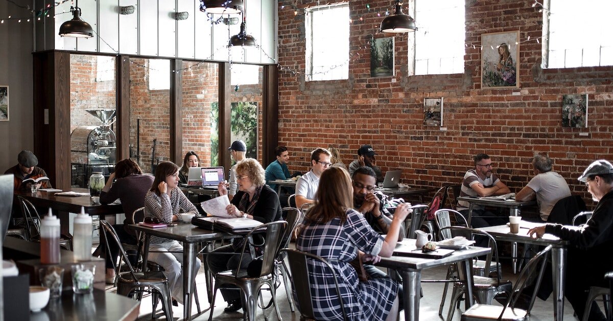 Exposed brick wall coffee shop with lots of people