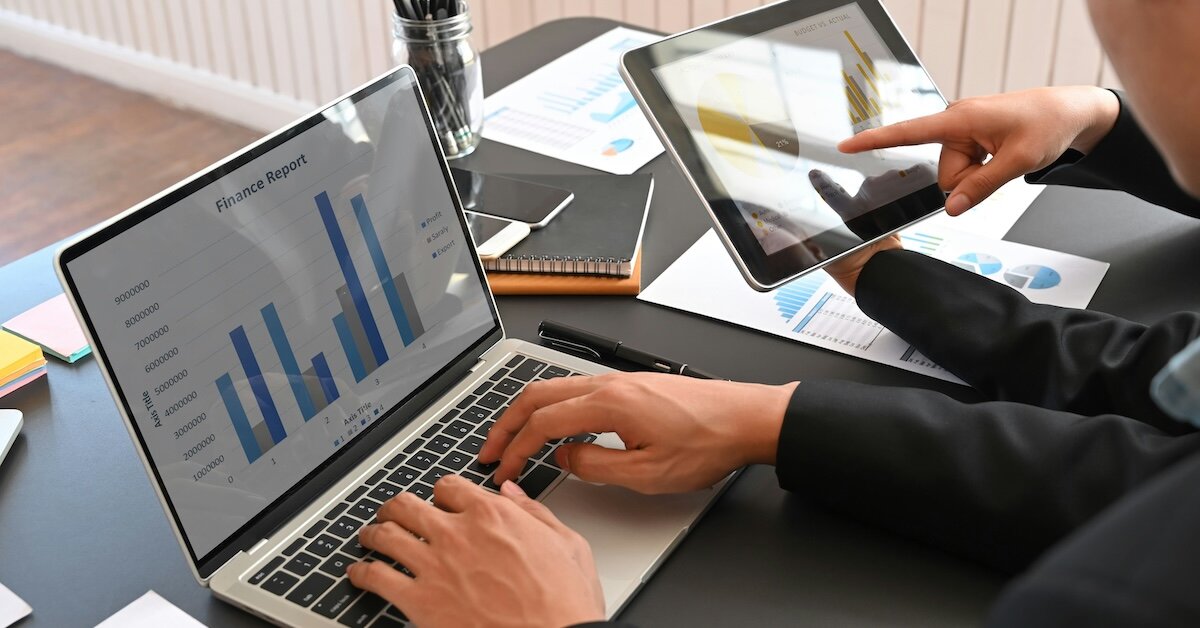 A person analyzing a data sheet with calculator