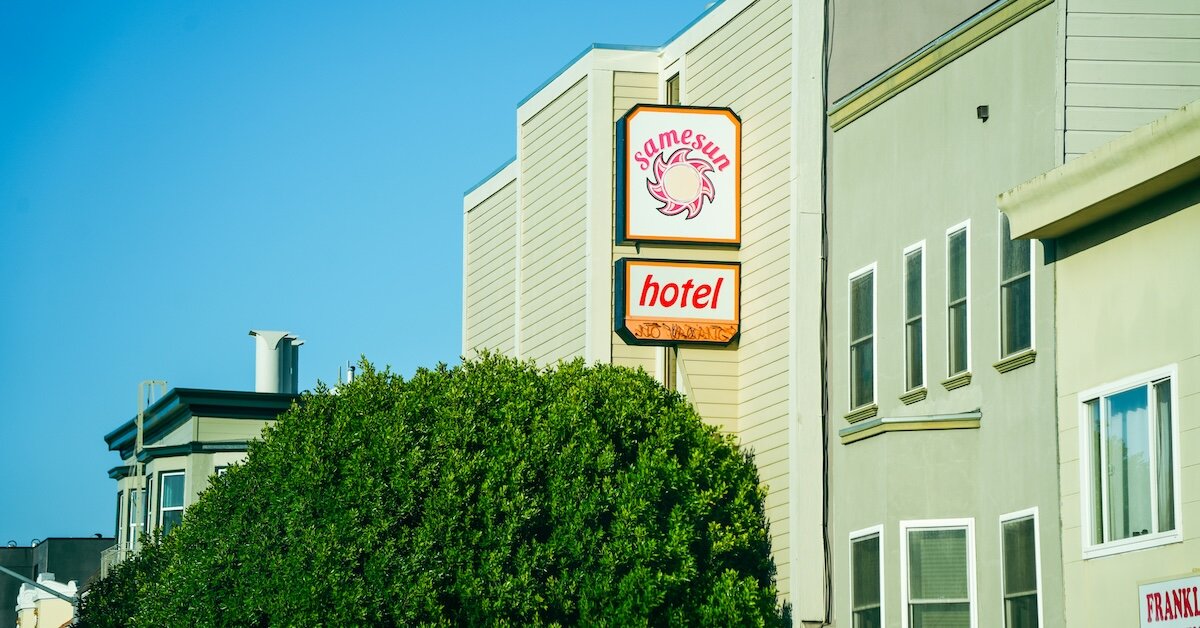 A motel with a sign reading "Hotel" in the foreground