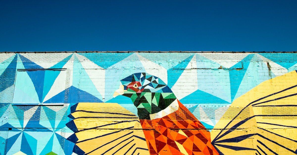 A mural of a bird in Detroit's cityscape