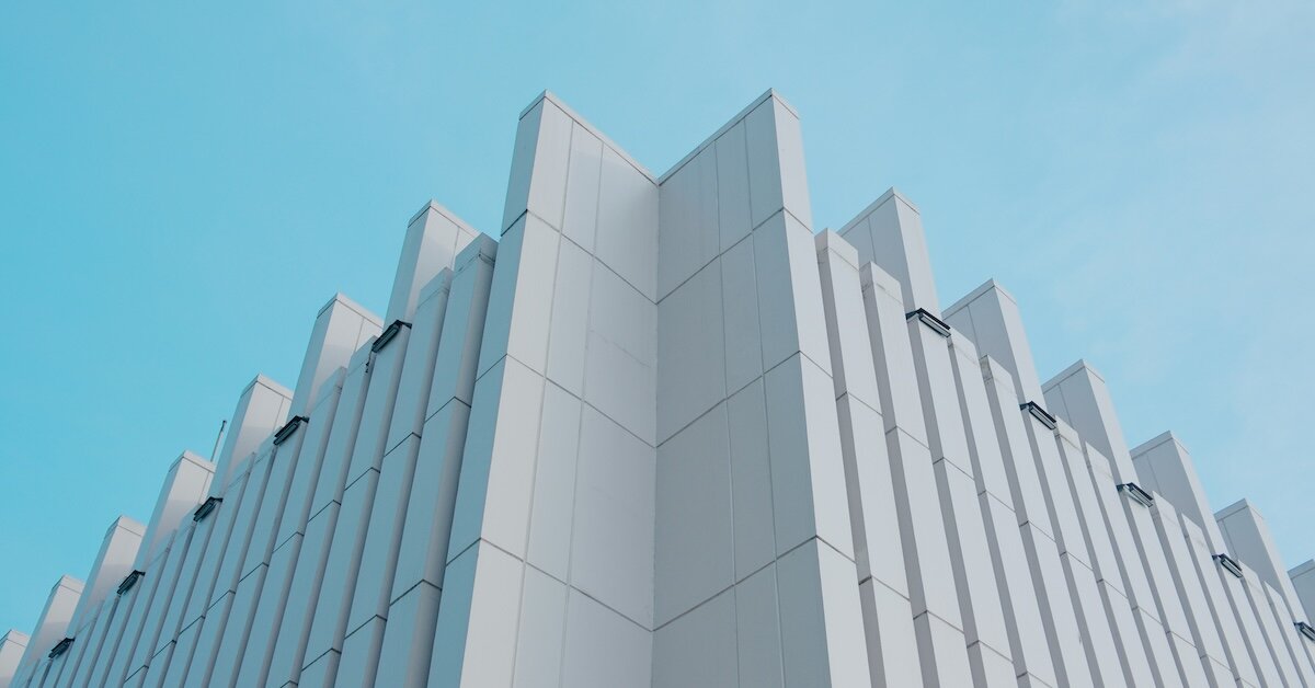 A symmetrical building white against a blue sky