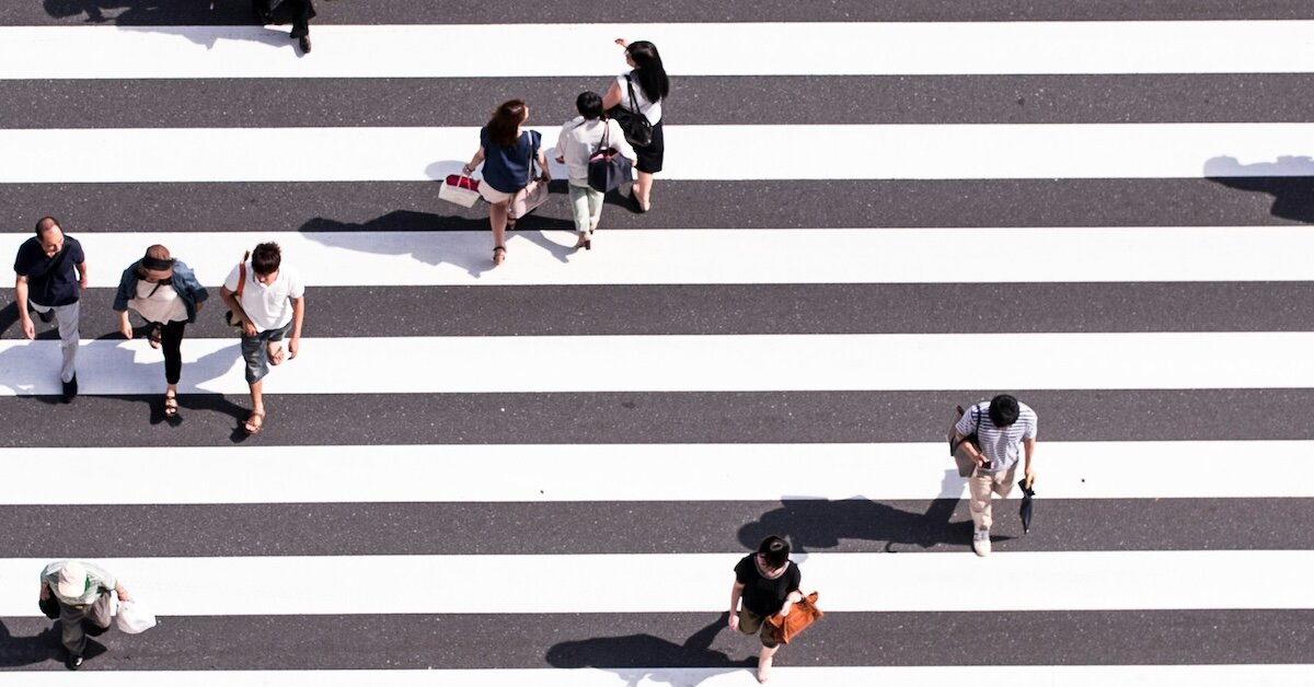 people walking across the street 