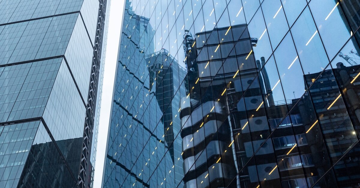 A reflection of a nearby skyscraper in a commercial building