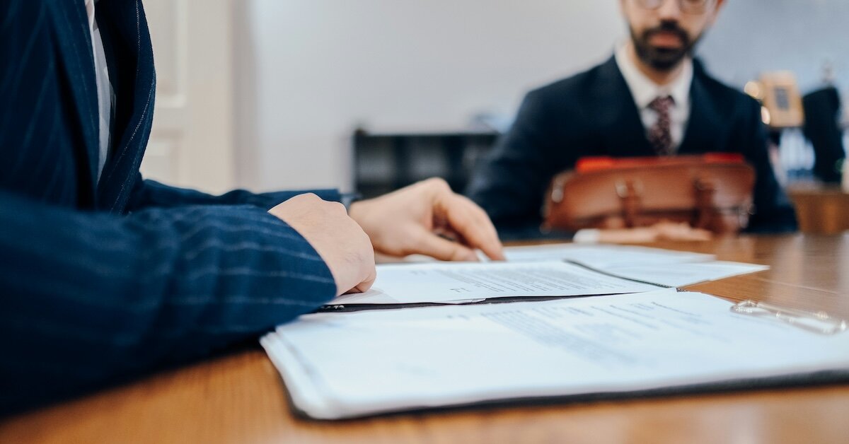 Folks discussing a CRE loan application at a meeting table