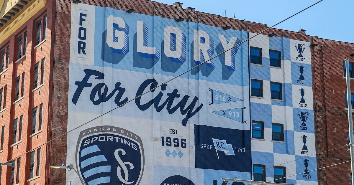 A mural outside of Kansas City on the side of a brick multifamily building