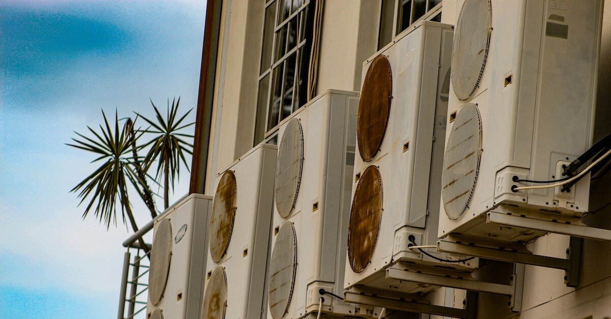 Several electrical and air conditioning unit boxes on a building