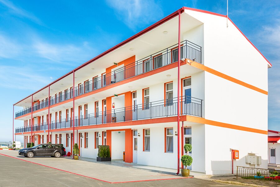 A white and orange hotel building