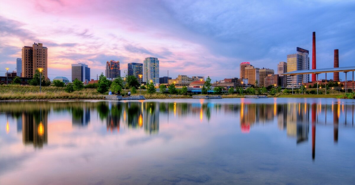 Birmingham's downtown skyline reflected in a nearby body of water