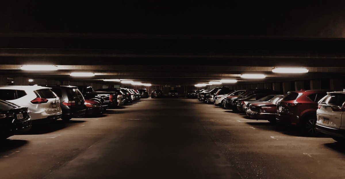 cars parked inside a darkly lit parking garage