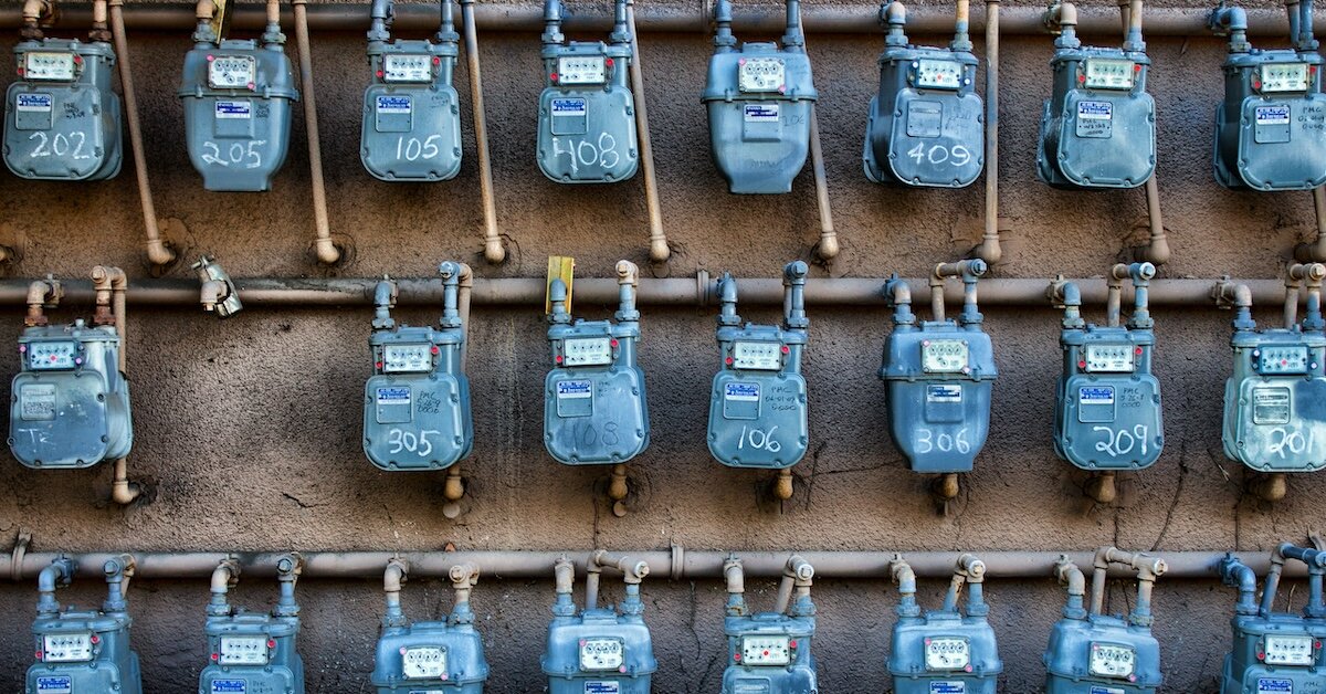 Several rows of blue utility meters for individual tenants in a commercial property